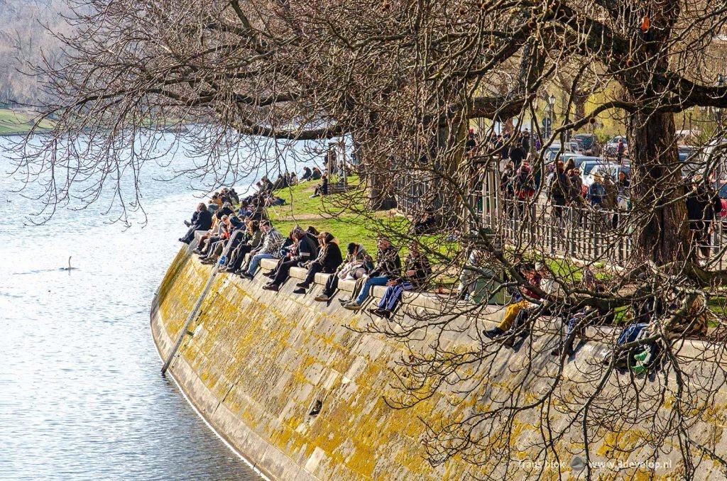 Relaxed mood on the bank of Landwehrkanal in Kreuzberg, Berlin, on a sunny day in spring