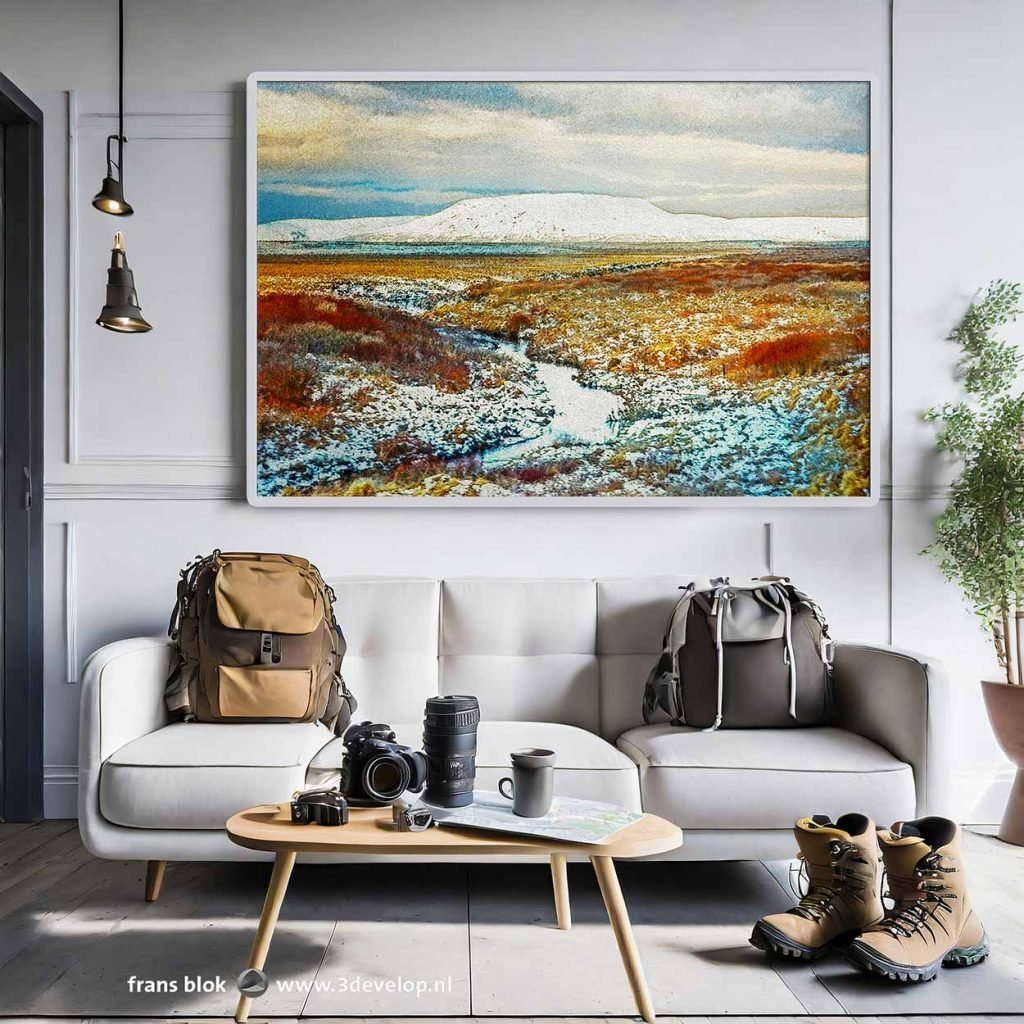 Living room with backpacks, camera and hiking boots and on the wall a framed painting of a snowy landscape in Iceland with a stream and a volcano